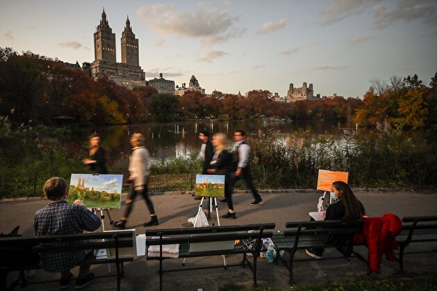 People enjoy autumn foliage at the Central Park in New York City