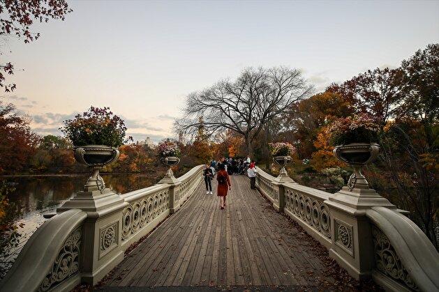 People enjoy autumn foliage at the Central Park in New York City