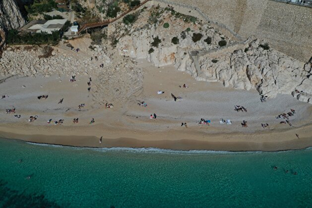Tourists flock to deserted beaches while locals confine at home in Turkey's Antalya