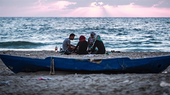 İsrail ablukası altındaki Gazze'de Filistinli aileler, sıcak havaların da etkisiyle iftarlarını Gazze sahilinde yaptı. 