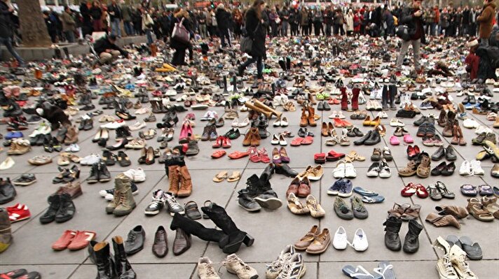 Hundreds of pairs of shoes are displayed at Repunligue square during a demonstration ahead of UN  climate change conference