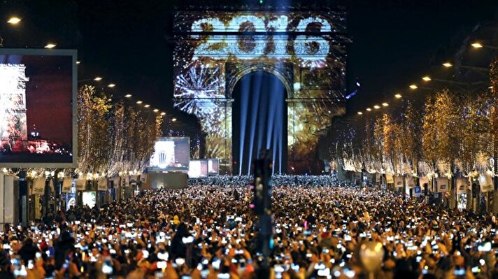 People watch as fireworks explode over Copacabana beach during New Year celebrations in Rio de Janeiro, Brazil,