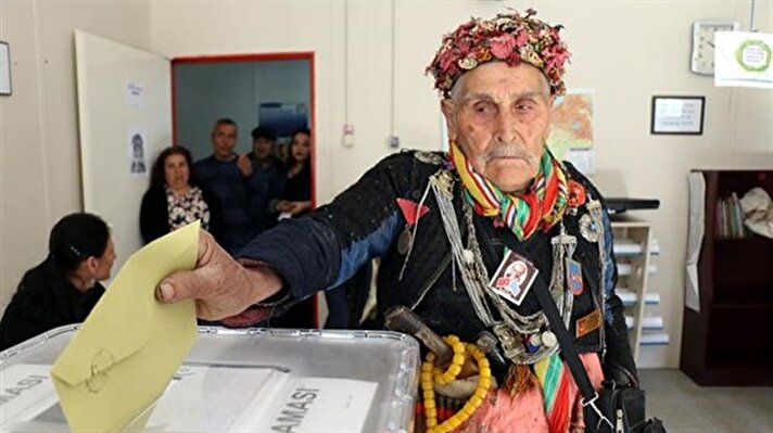 Within the historical constitutional referendum, some citizens cast their votes wearing traditional clothing. 