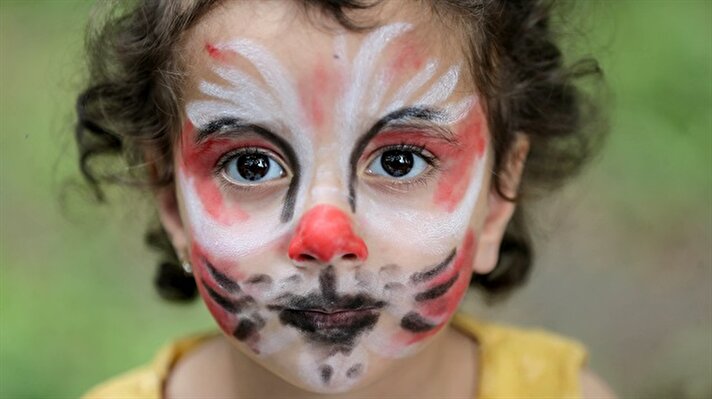 A girl poses with coloured face during the World Refugee Day celebrations which is held by the UN Refugee Agency at Veliefendi Race Course in Istanbul, Turkey on June 20, 2017.