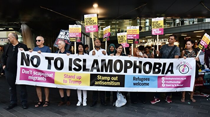 Protesters hold a banner reading "No To Islamophobia - Don't Scapegoat Migrants - Stand Up To Trump - Stamp Out Antisemitism - Refugees Welcome" at a vigil for Resham Khan and Janeel Muhktar who were attacked with sulphuric acid in London, United Kingdom on July 05, 2017. Muhktar has stated that the attack was a hate crime and believed ‘It’s something to do with Islamophobia”. The police are looking for John Tomlin in connection with the crime.