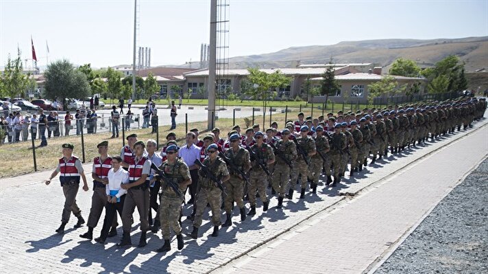 Defendants Kemal Batmaz (first row C) and Akin Özturk (second row 2nd L) and other defendants arrive for their trial 