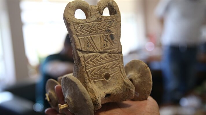 A 5,000-year-old toy chariot and wheels that are found during the ongoing excavations in the ancient city of Sogmatar in the southeastern Turkish province of Sanliurfa is seen on October 2, 2017.