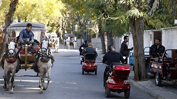 People ride their bicycles and electric-powered tricycles on an autumn day in Buyukada of Prince Islands of Istanbul, Turkey on November 16, 2017. Environmentally friendly electric vehicles are being used widely in Prince Islands, the only district in Turkey where fuel-consuming vehicles are not allowed. The Prince Islands, consist of Buyukada, Heybeliada, Burgazada and Kinaliada, do not host fossil fuel-consuming vehicles other than fire truck, police cars, ambulance and some municipal vehicles. In the whole of the islands there are phaetons for passenger transport and horse carriages for freight transport. There are also a large number of bicycles, as well as cordless vehicles such as rechargeable electric bicycles, scooters, motorbikes and golf carts.

