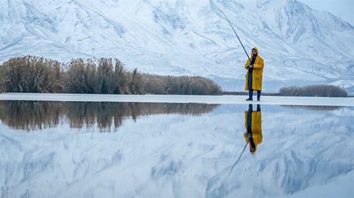 Fishing on frozen lake in Van