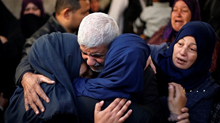 Relatives of a Palestinian man, who was shot by Israeli troops on Friday, mourn during his funeral