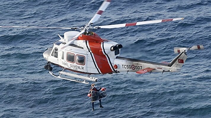 urkish Coast Guard helicopters fly over the Aegean Sea within a rescue operation for the refugees stuck in rocks in offshore Dikili district of Izmir, Turkey on December 14, 2017. The refugees, including women and children, were trying to reach Greek Islands when an inflatable boat carrying them got stuck at the small islet near Dikili district of Izmir, according to a statement from the Turkish Coast Guard. The coast guard teams airlifted four children, while the others were transferred to safety in boats.

