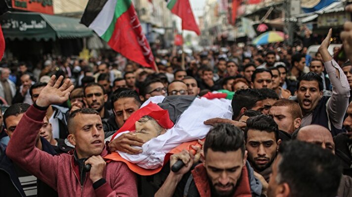 People attend the funeral ceremony of Muhammed Nebii Muhaysin (29), who was martyred by Israeli security forces during a demonstration against U.S. President Donald Trump's recognition of Jerusalem as Israel's capital, in Shuja'iyya neighborhood of Gaza City, Gaza on December 23, 2017.​