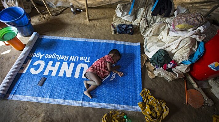 A kid sleeps on an United Nations High Commissioner for Refugees (UNHFR) mat on the floor at a refugee camp in Cox's Bazar, Bangladesh on December 27, 2017. Rohingya Muslims live in makeshift tents made of bamboo, mud-brick and plastic. Children here sleep on swings or on the floor unaware of their families' situations. The camps in Bangladesh host thousands of Rohingya refugees who fled a military crackdown in Myanmar. Approximately 650,000 Rohingyas have crossed from Myanmar into Bangladesh since Aug. 25, according to UN figures.


