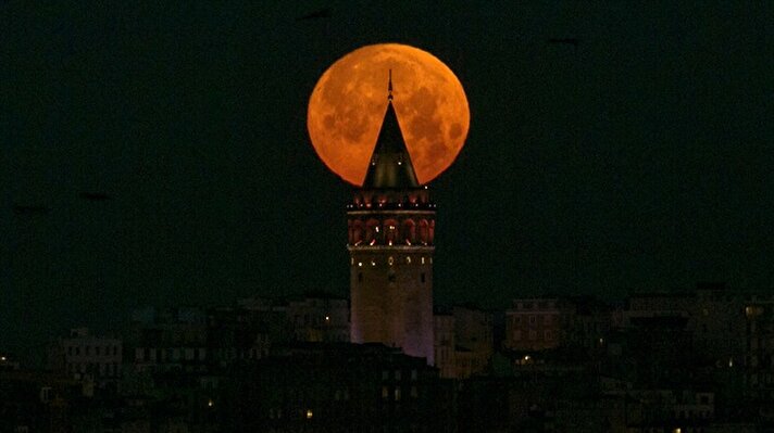 Full moon is seen over Galata Tower in Istanbul, Turkey

