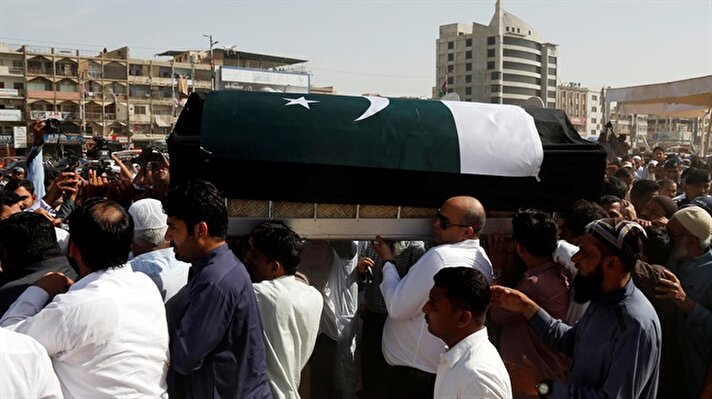 Aziz Sheikh father of Sabika Aziz Sheikh, a Pakistani exchange student, who was killed with others when a gunman attacked Santa Fe High School in Santa Fe, Texas, U.S., sits in an ambulance next to her coffin, wrapped in national flag, during a funeral in Karachi, Pakistan May 23, 2018. 