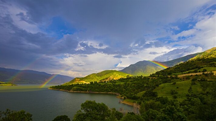 A Rainbow occurs after a rainy day as the sun goes down following a rainy day during spring season near River Murat in Palu district of Elazig, Turkey​.