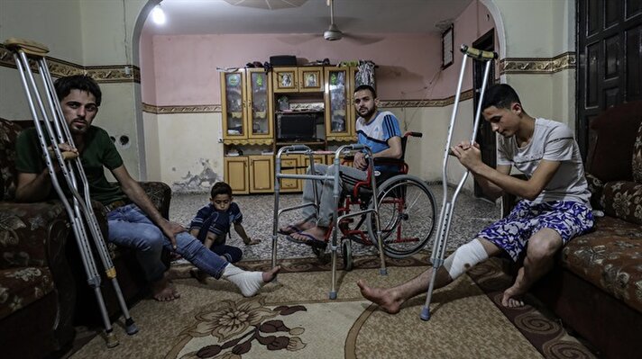 Three Palestinian brothers from the Gaza Strip were condemned to a life of disability after Israeli bullets pierced their limbs during the Great March for Return protests near the Gazan border. One of the brothers was condemned to a life in a wheelchair, while the other two can only walk with the help of a crutch.

