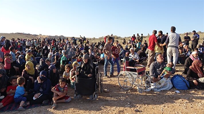 Syrians wait at the border areas near Jordan after they fled from the ongoing military operations by Bashar al-Assad regime and its allies in Syria's Daraa.“Over 150,000 people have fled to the plains near the Jordanian border due to intense strikes by the Syrian regime and its allies on cities and towns in Daraa's countryside.​