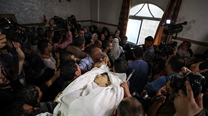Relatives mourn near the bodies of Palestinian children Amir al-Nimra (15) and Louay Kahil (16) who lost their lives after Israeli army carried out airstrikes, during a funeral ceremony in GazaCity, Gaza

