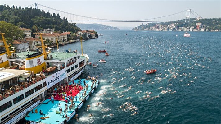 A ferry carries swimmers to the starting point