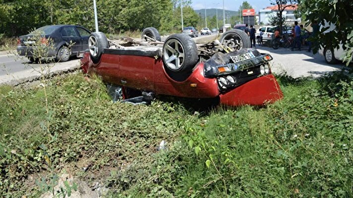 Bartın'da, aracın sıkıştırması sonucu sürücüsünün direksiyon kontrolünü yitirdiği otomobil, kaldırıma çarparak takla attı. Ters dönen otomobilden sürücü yaralanmadan kurtuldu. (DHA)
