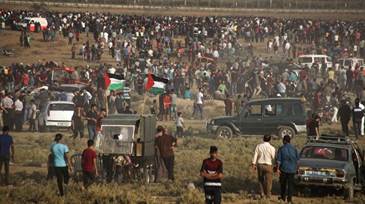 Palestinians gather during a "Great March of Return" demonstration, on the 24th Friday of the protests, on the Israel-Gaza border near Jabalia Refugee Camp in Gaza City, Gaza.

