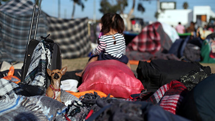 Migrants, part of a caravan of thousands from Central America trying to reach the United States, rest outside of a temporary shelter in Tijuana, Mexico.

