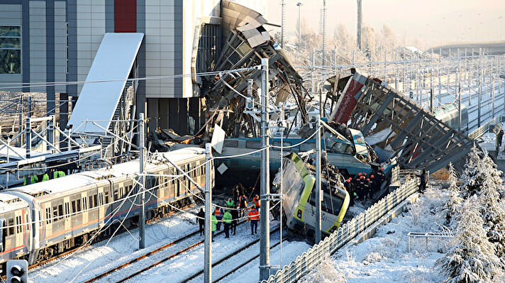 Rescue workers search at the wreckage after a high speed train crash killed seven and injured 43 in Ankara, Turkey.  