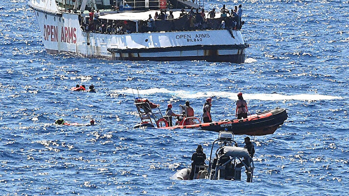 Migrants jump off the Spanish rescue ship Open Arms, close to the Italian shore in Lampedusa, Italy August 20, 2019. REUTERSGuglielmo Mangiapane 
