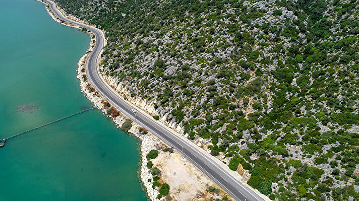 A drone photo shows an aerial view of a road and a sea through a bay in Finike district of Antalya, Turkey on August 6, 2019. Antalya, one of the most outstanding tourist attraction cities all over the world in terms of diversity of beaches, bays, historical places, natural beauties and sea, is hosting millions of tourists.
