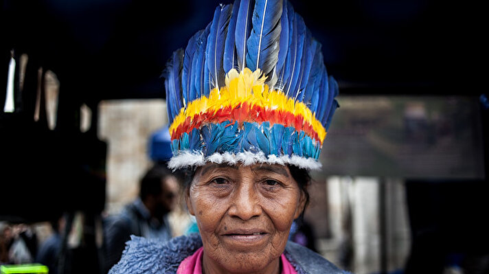 An indigenous woman of Colombian Amazon poses for a photo as she visits a market for cultural exchange in Bogota, Colombia on August 20, 2019.
