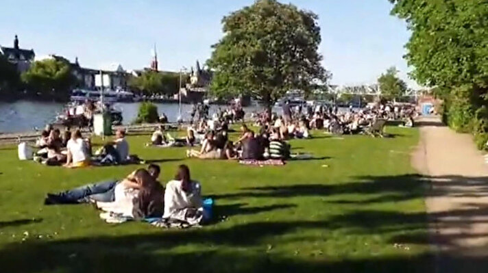 Almanya'nın Frankfurt kentinde pazar tatilini ve güneşli havayı fırsat bilen vatandaşlar, sosyal mesafeyi hiçe saydı, birçok kişi şehrin Main Nehri kıyılarına akın etti. 