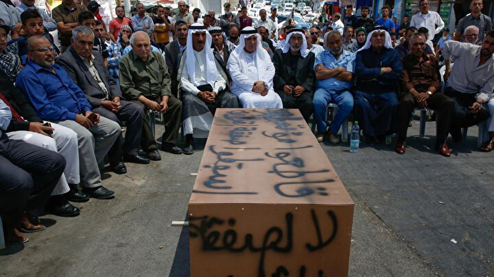 Filistinliler, çalıştayı üzerinde '' Yüzyılın Anlaşması'' na hayır! yazılı tabutla protesto etti.