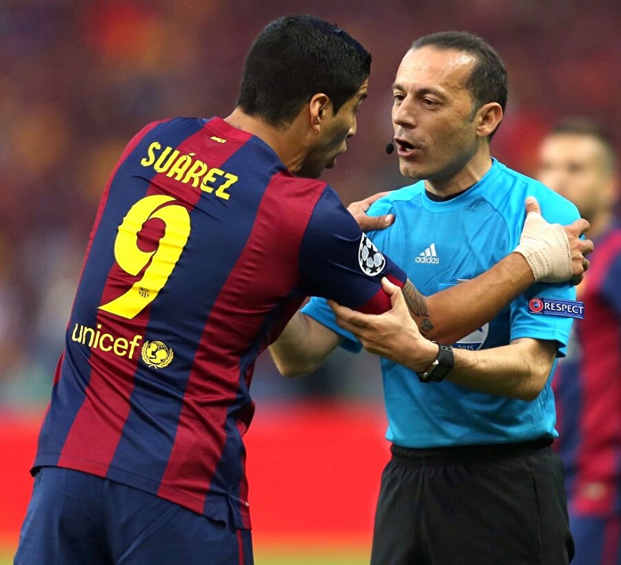 Cüneyt Çakır, Luis Suarez'in hararetli itirazlarını dinlerken.