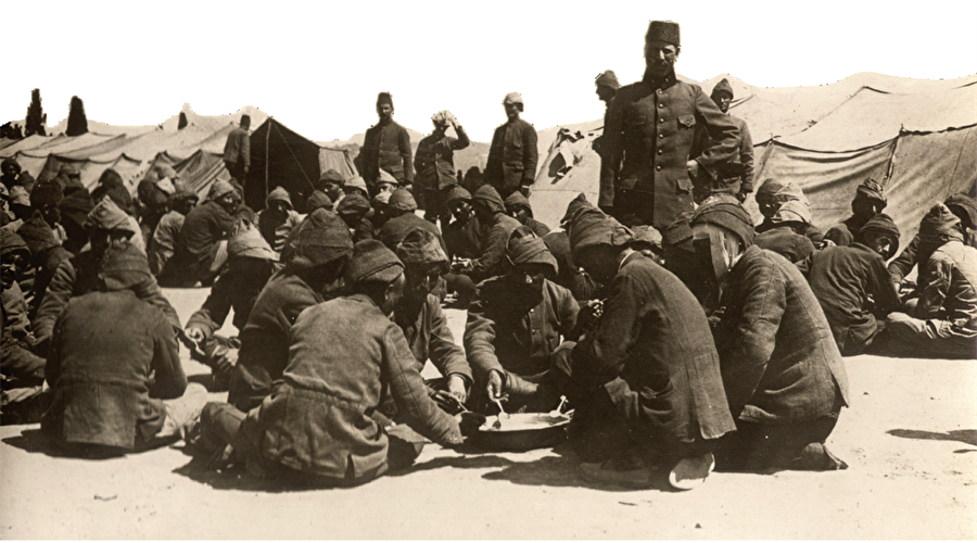 Paylaşılan lokmalar Kûtu’l-Amâre’de düşmanın yanı sıra açlık ve hastalıkla da mücadele ediliyordu. Irak Cephesi’nde karavanalarını paylaşan Osmanlı askerleri.