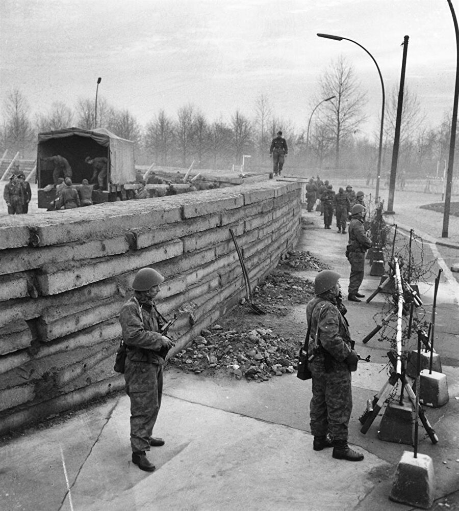Berlin Duvarı'nın inşası sırasında askerler nöbet tutuyor.