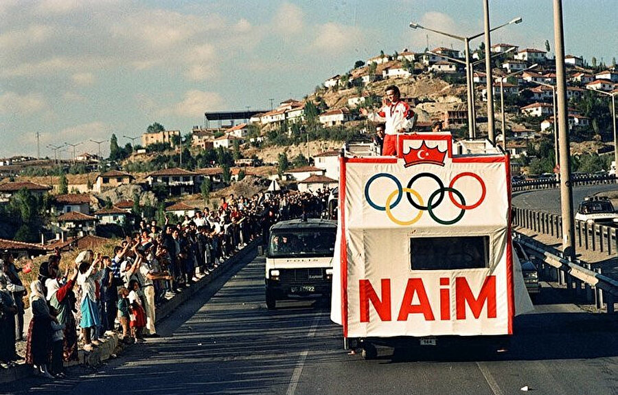 Dünya ve Olimpiyat Şampiyonu milli halterci Naim Süleymanoğlu yurda döndükten sonra vatandaşları selamlıyor.