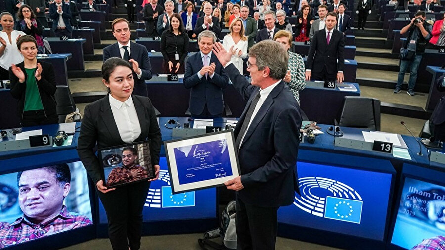 İnsan hakları aktivisti İlham Tohti'nin kızı Gohar Elham, Avrupa Parlamentosu adına ödül almak için tören sırasında babasının fotoğrafını elinde tutuyor 