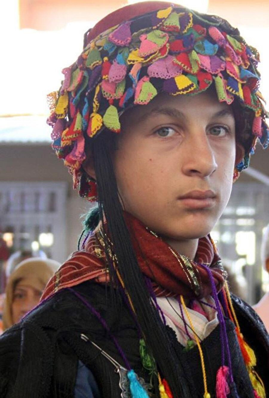 Efelere özgün iğne oyalı fes giyinmiş bir genç