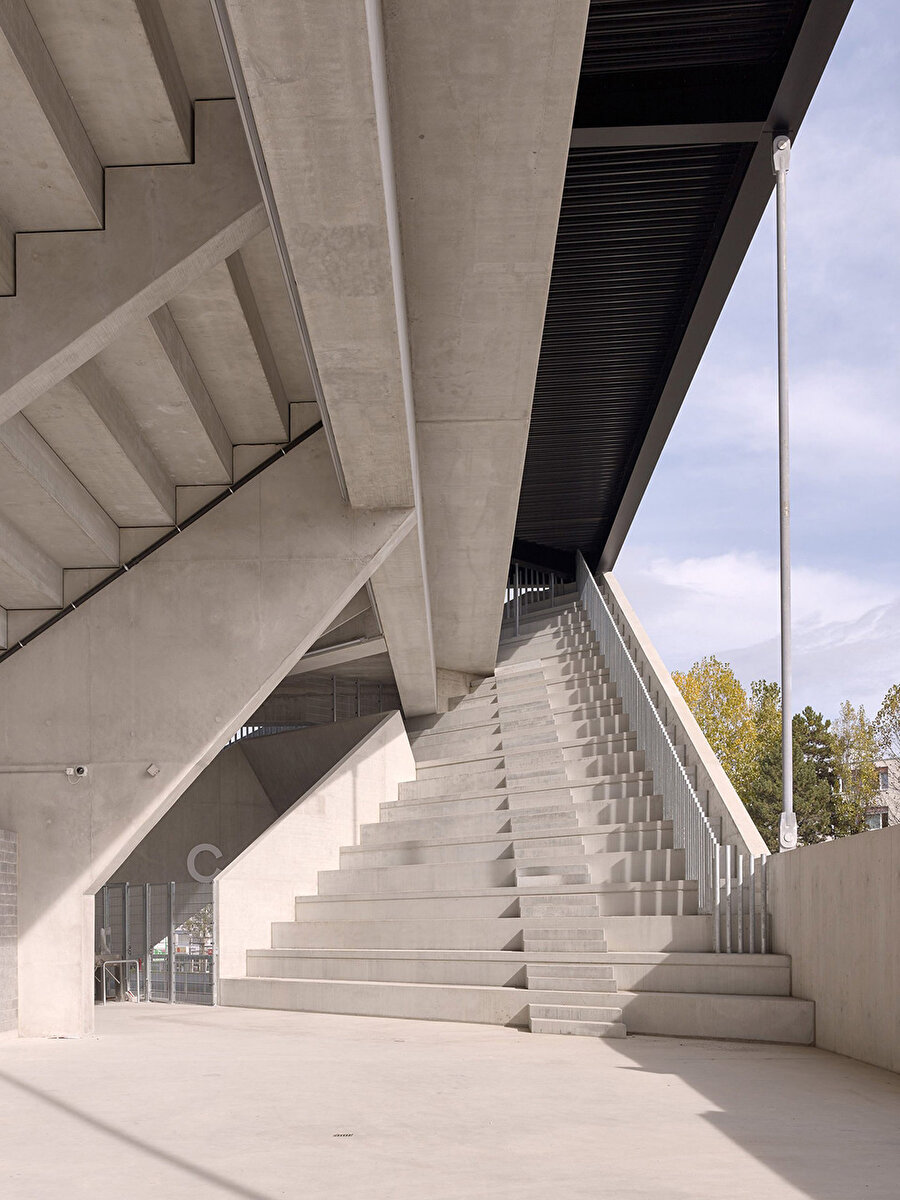 Betonarme tribünler, alt kısımlarında büfelerin olduğu kamusal toplanma alanı oluşturuyor.