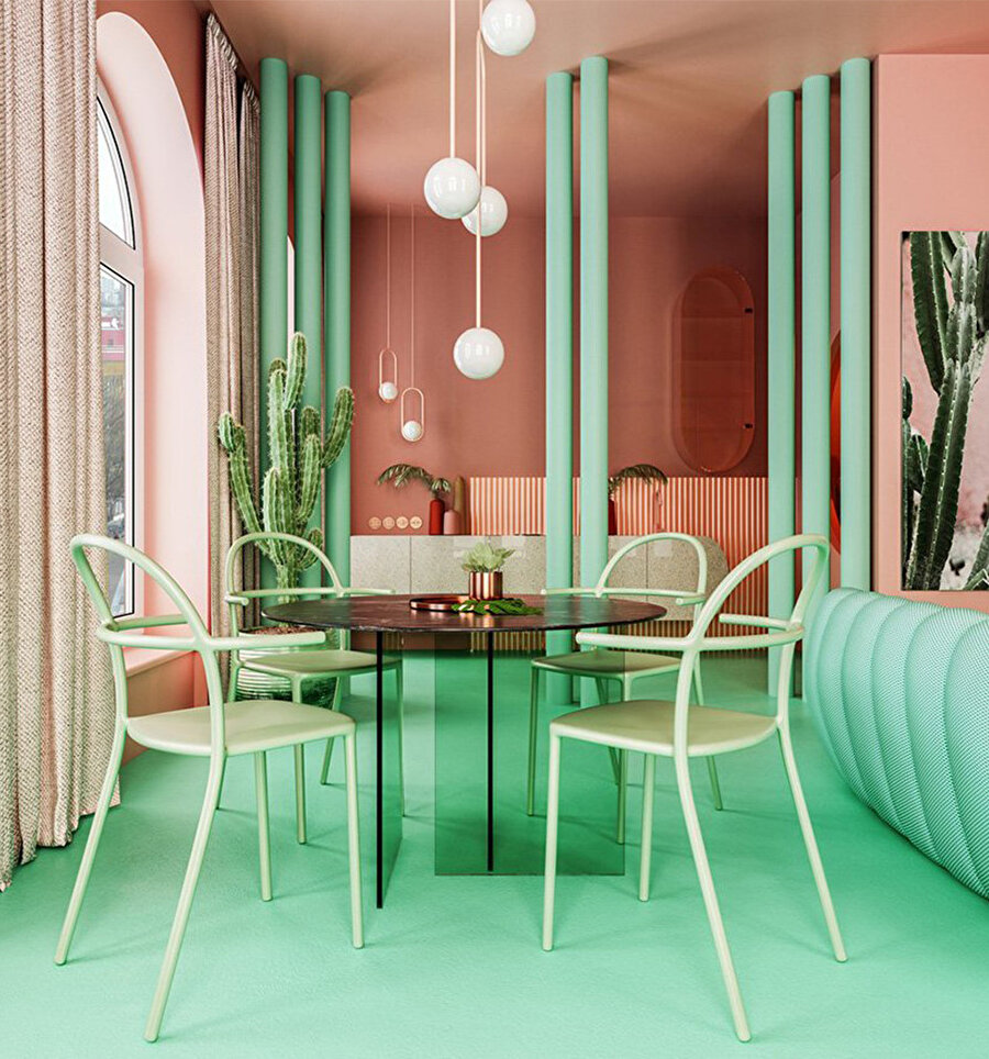 Yemek alanında, yeşil cam bir masa, yine aynı renk sandalyeler ve sarkıt lambalar bulunuyor.