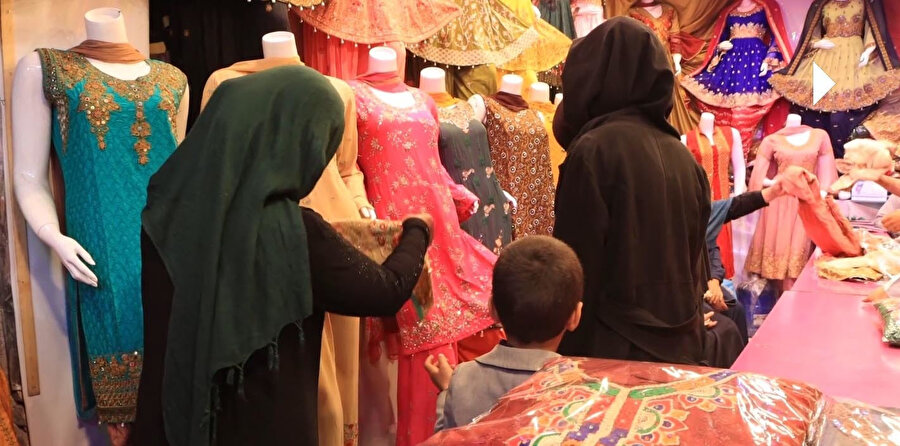 Çocukları ve kendileri için bayramlık alışveriş yapan Afgan kadınlar. 