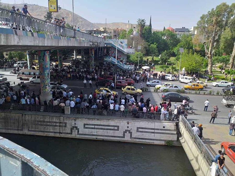 Onlarca Suriyeli, 3 Mayıs 2022'de cezaevinden tahliye edilenler arasında olmasını umdukları akrabalarını Şam'daki Cumhurbaşkanlığı Köprüsü'nde bekliyor.