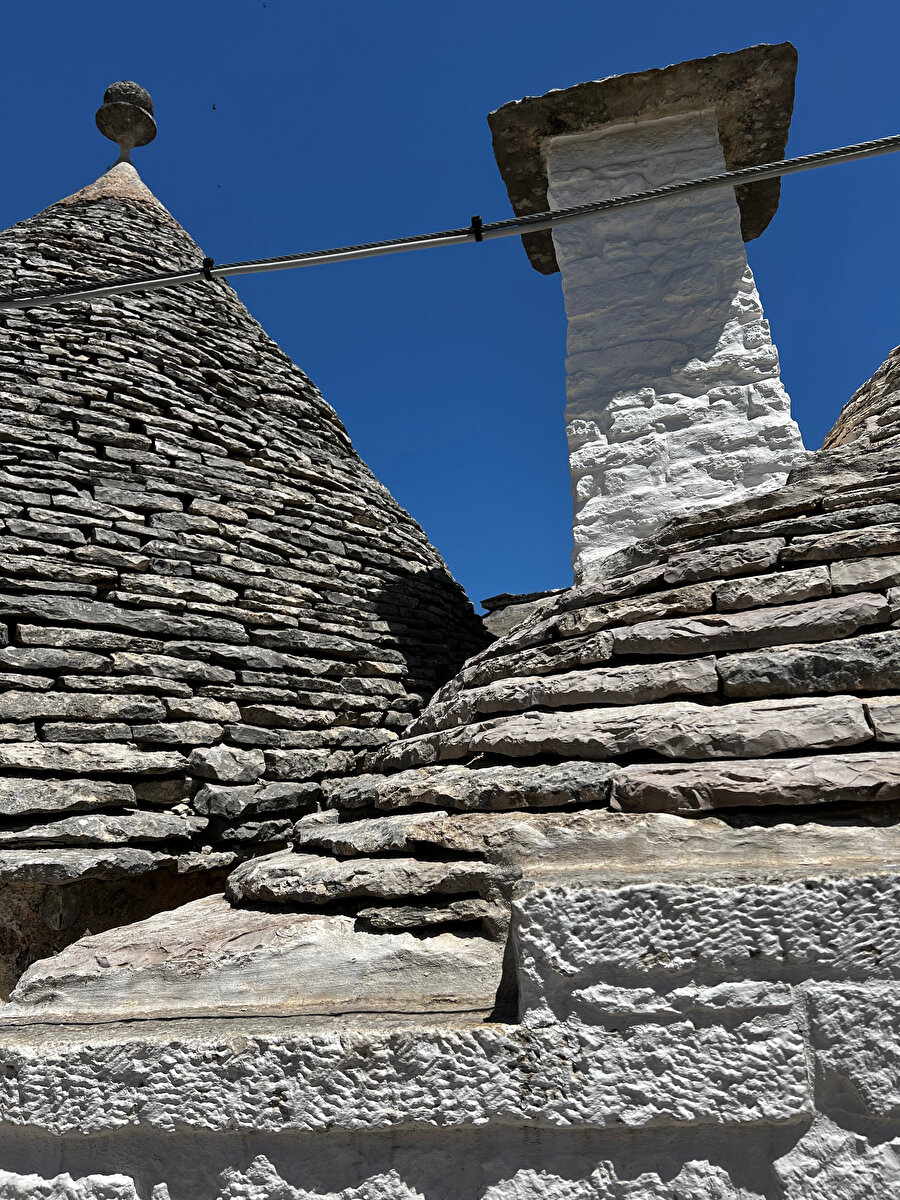 Trulli Tipi yapıların konik forma sahip çatılarında bindirme kuru taş yapım tekniğinin kullanımı dikkat çekiyor. Selcen Kürklü