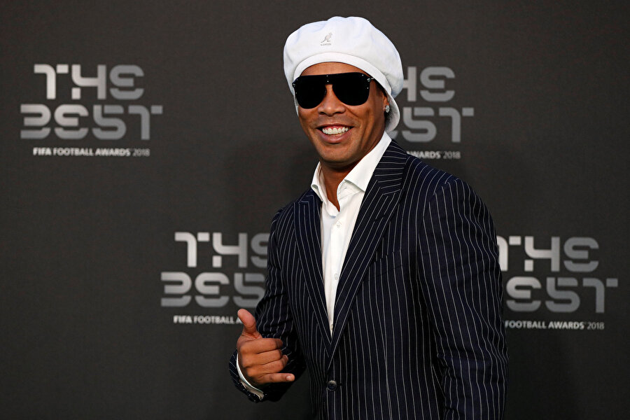 Ronaldinho, Ballon d'Or ödüllerine katıldığı kıyafetiyle gazetecilere poz veriyor.