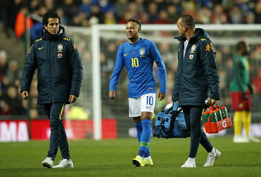 Oyuna devam edemeyen Neymar, acı içinde sahadan ayrılırken...