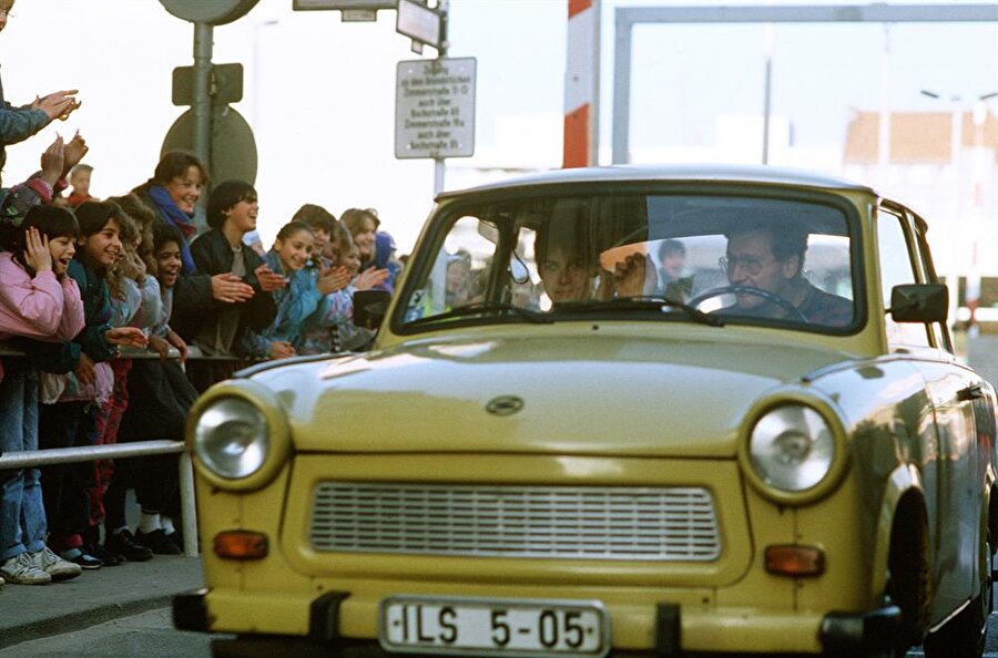 NASIL YIKILDI?
Trabant ile Checkpoint Charlieyi geçerek Batı Berlin'e giren Doğu Almanyalı bir çift ve onları alkışlayarak karşılayan Batı Almanyalı çocuklar (14 Kasım 1989)