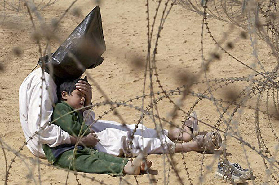 2003 Jean-Marc Bouju
Iraklı adam, savaş esirlerinin tutulduğu bölgede çocuğunu rahatlatmaya çalışıyor.