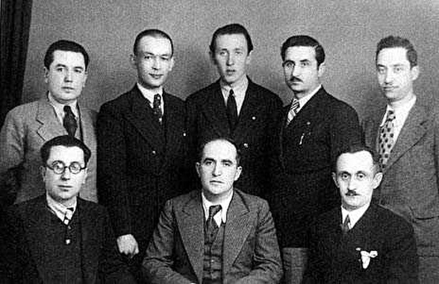 Bir garip Orhan Veli
Üzerine çok şey yazılıp çizildi, çokça oyun, çokça kitap derlendi, yayımlandı. Ispanağı ve pufböreğini sevdiğini haykırdı, ama Nahit Hanım'a olan aşkını ancak mektuplaşmalarından okuyabildik; “Edebiyat tarihçisi bulsun,” dedi, çok durmadı üzerinde.
O, her sabah gökyüzünü boyayan, yırtılan denizi diken, ne halt edeceğini bilemeyen bir “Dalgacı Mahmut”tu. Aşklarını çok makaraya aldı, ama dalga geçtikçe daha çok belli etti iyi bir âşık olduğunu.
Daha ilköğreniminde edebiyata olan ilgisi öğretmenlerince dikkati çekti, kütüphanelerde geçen zamanlar, Çocuk Dünyası dergisinde yayımlanan ilk öykü… Ankara Lisesi'ne başlamasıyla bambaşka bir yola girer Orhan.
Okuldaki edebiyat öğretmeni
Ahmet Hamdi Tanpınar'dır. Düzyazıya olan ilgisi başlarda daha çok olsa da lise yıllarındaki karşılaşmalarıyla şiire de ilgi duymaya başlar. Bu ilgi, ileride “Garip üçlü” olarak adının birlikte anılacağı Oktay Rifat ve Melih Cevdet Anday'la tanışmasıyla daha da artar. Oktay Rifat'ın Orhan Veli ile ilgili şu cümleleri, durumu özetler niteliktedir: “İkimiz de şiir delisi idik. Orhan zil çalar çalmaz yanıma gelir. 'Teneffüsü gâvur etmeyelim Oktay,' derdi. Şiir sözü edelim, şiir konuşalım demekti bu.”
“Garip üçlü”nün ilk şiir denemeleri Varlık'ta düzenli olarak yayımlanır, şiirleri ayrı sayılarda yer alsa da, üç ismin ortak hareket ettiği görülür. Şiire dair geçirilen arayış evresinin yavaş yavaş sonuna gelinir ve 1941 yılında
Garip adlı kitap yayımlanır. Üçlünün şiirlerinin ve Orhan Veli'nin poetik görüşlerini dile getirdiği önsözünün yer aldığı kitap çokça olumlu olumsuz eleştiri alır.
Söz konusu önsözde, birçok kalıbın yıkılmaya çalışıldığı, şiirin yeniden tanımlandığı görülür. “
Bütün hususiyeti edasında olan” ve “İnsanın beş duyusuna değil, kafasına hitap eden bir söz sanatı” olarak tanımlanır şiir. Karşı çıkılan anlayışlardan da söz edilir, yani hece şiiirine, toplumcu gerçekçi şiire, özellikle de Ahmet Haşim'in benimsediği şiir anlayışına.
Orhan Veli, iyi bir gözlemcidir. İnsanları, onların yaşadıkları hayatı titizlikle gözlemler ve bunları konuşma dilini kullanarak şiirlerine, adeta bir öykü yazarı gibi yansıtır. Şiir içinde öykü, öykünün içinde yaşama heyecanı vardır.