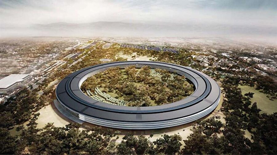 
                                    Apple, geleneksel kurumsal kampüs yerine 12.000 işçisini Cupertino'da tek bir binada buluşturmayı hedefliyor. Steve Jobs, fütüristik bir tasarıma sahip bu yuvarlak yapıyı bir uzay gemisine benzetiyordu.
                                
